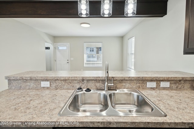 kitchen with light countertops and a sink