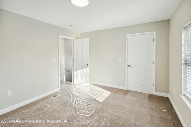 unfurnished bedroom with visible vents and baseboards