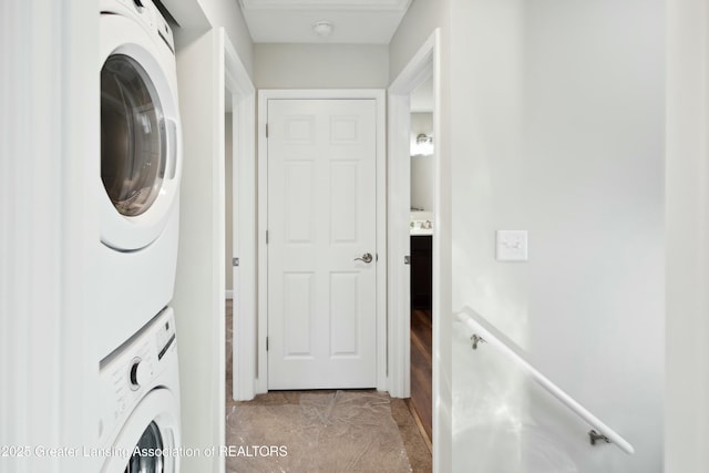 clothes washing area featuring laundry area and stacked washer and dryer