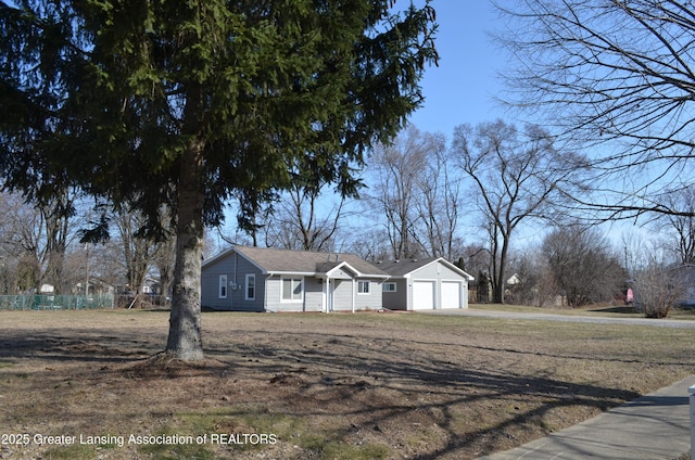 view of front of home with driveway, a front lawn, and a garage