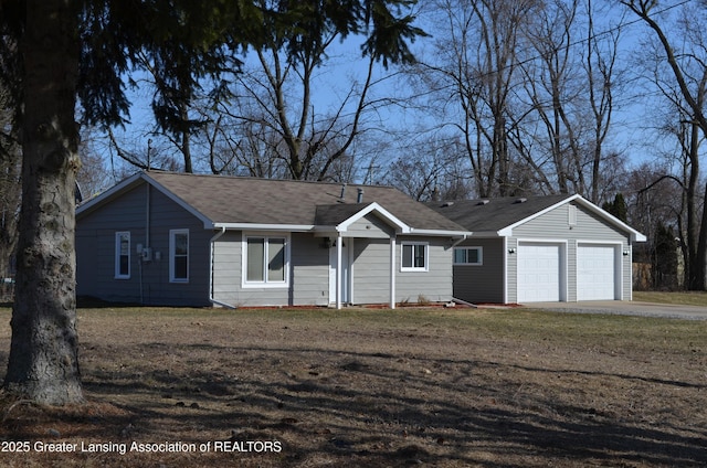 ranch-style home with a front yard, a garage, and driveway