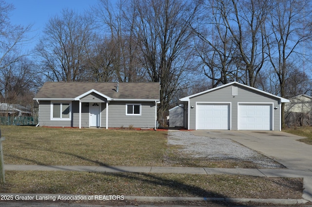 ranch-style house with a detached garage, an outbuilding, and a front lawn