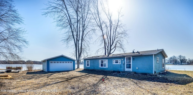 ranch-style home with entry steps, an outbuilding, and a garage