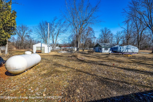 view of yard featuring an outbuilding and a garage