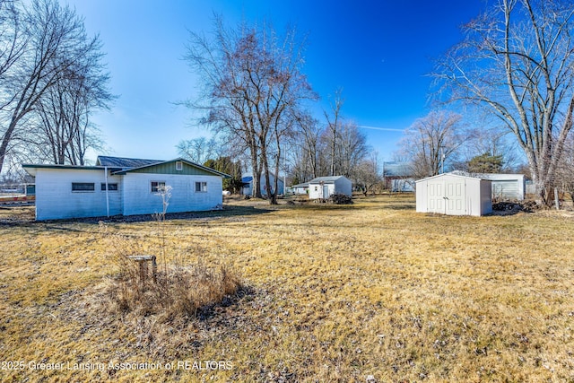 view of yard with an outbuilding and a storage shed