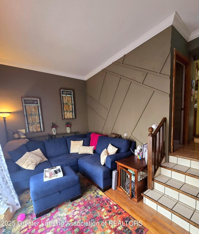 living area featuring stairway, wood finished floors, and ornamental molding