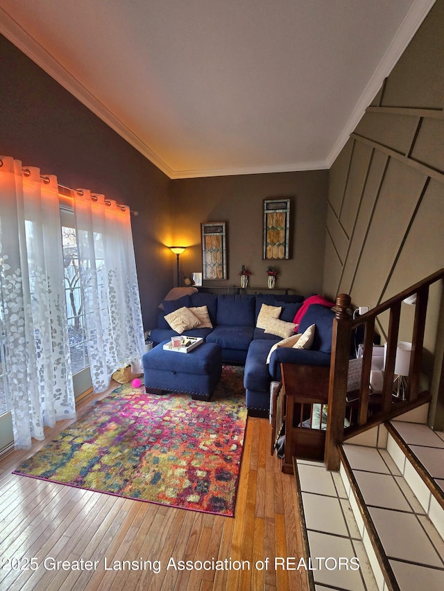 living area with wood-type flooring and ornamental molding