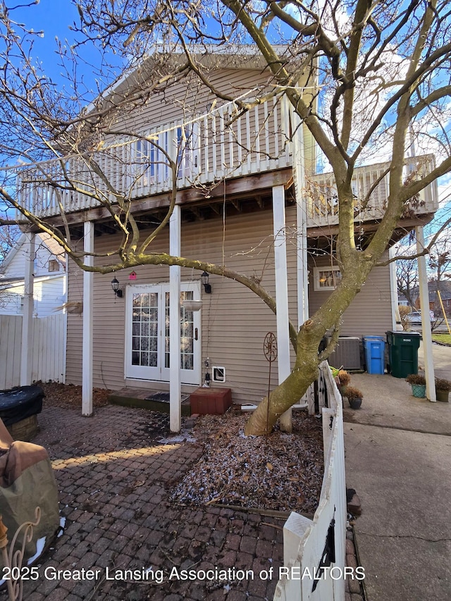 view of home's exterior featuring cooling unit and fence