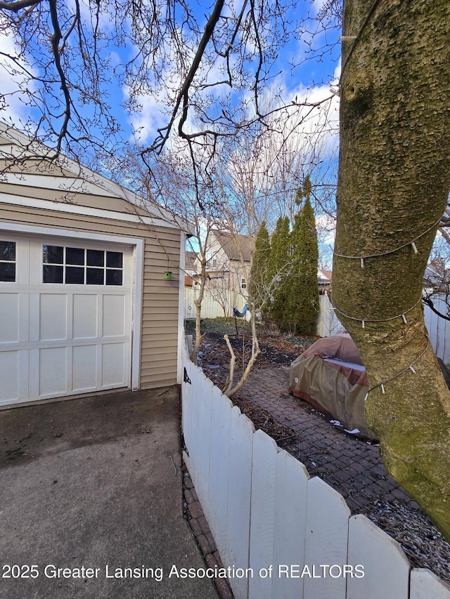 exterior space with an outdoor structure, fence, and a garage