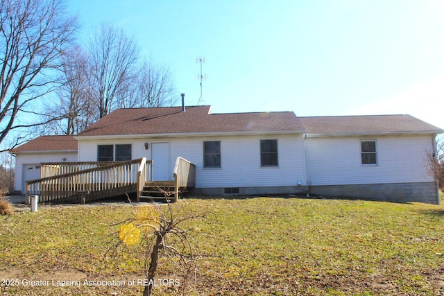 rear view of house featuring a lawn and a wooden deck