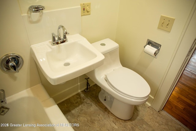 bathroom featuring toilet and a sink