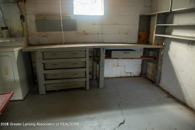 below grade area featuring washer / clothes dryer and concrete block wall