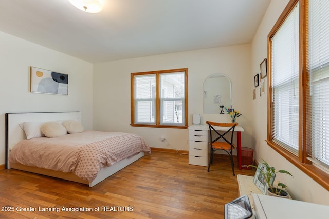 bedroom featuring baseboards and light wood-style floors