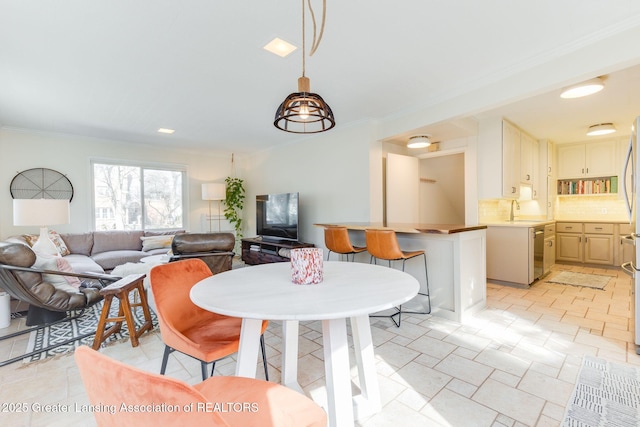 dining space featuring crown molding