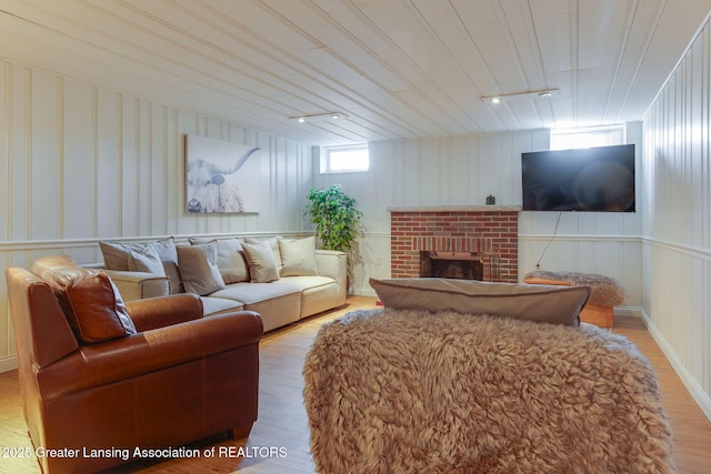 living room with a fireplace and wood finished floors