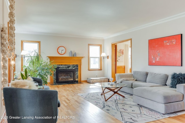 living room with plenty of natural light, wood finished floors, and ornamental molding