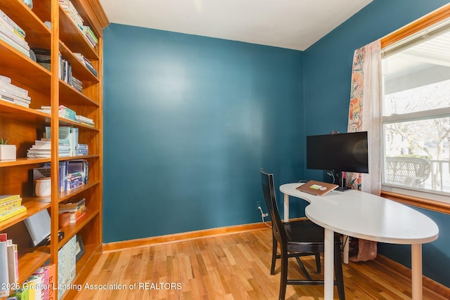 office space with wood finished floors and baseboards