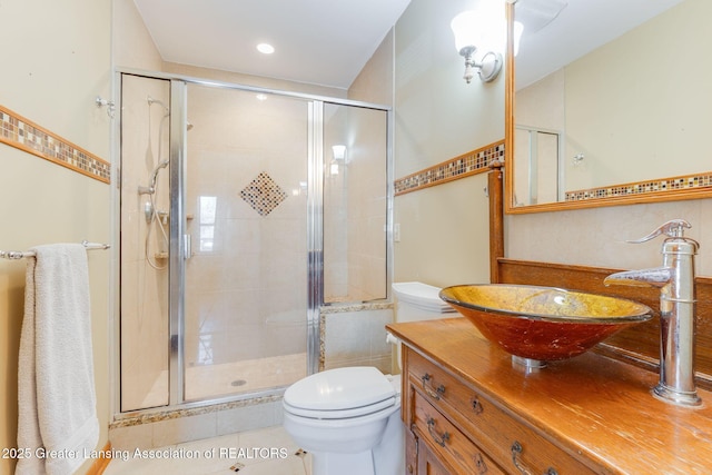 full bathroom with vanity, toilet, a stall shower, and tile patterned flooring