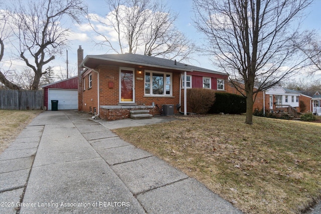 view of front of property with brick siding, fence, cooling unit, a chimney, and an outbuilding