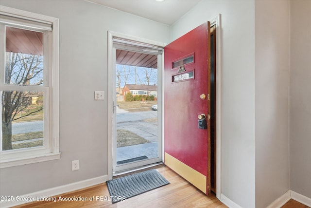 entryway with baseboards and light wood-type flooring