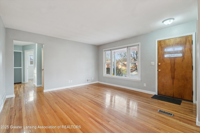 foyer with visible vents, baseboards, and light wood-style floors