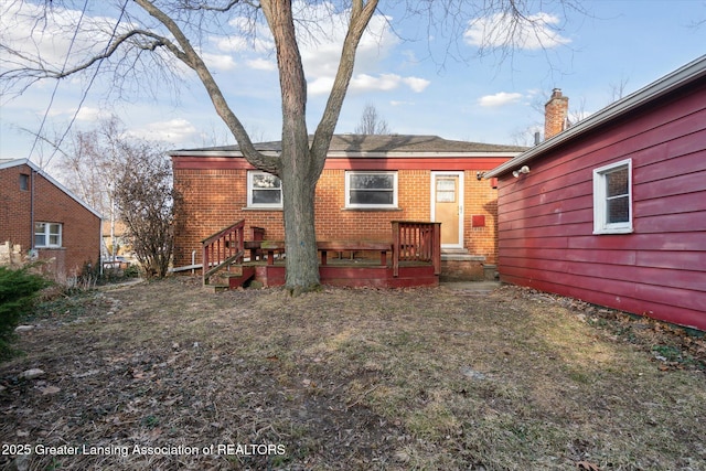 back of property featuring brick siding