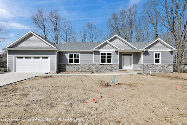 craftsman inspired home with stone siding, an attached garage, driveway, and roof with shingles