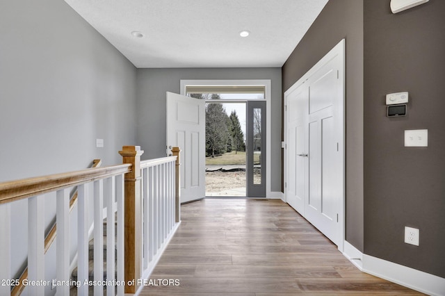 entryway featuring recessed lighting, baseboards, and wood finished floors