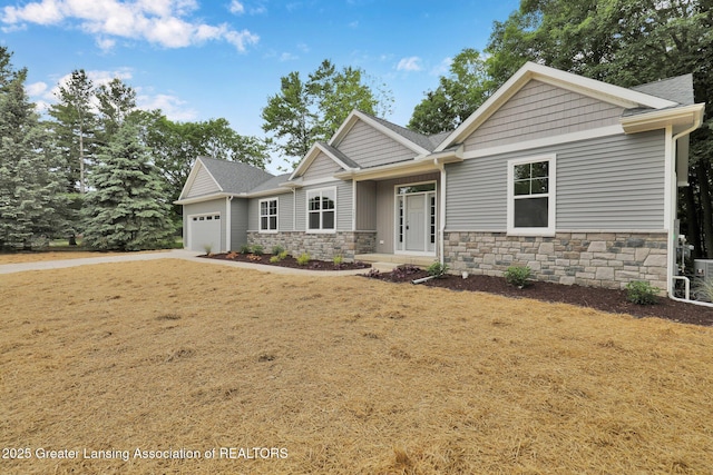 3427 W Broadmoor Dr, Lansing, MI 48906 - craftsman inspired home with stone siding, a garage, and a shingled roof