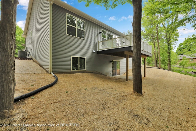 3427 W Broadmoor Dr, Lansing, MI 48906 - back of house featuring cooling unit and a wooden deck