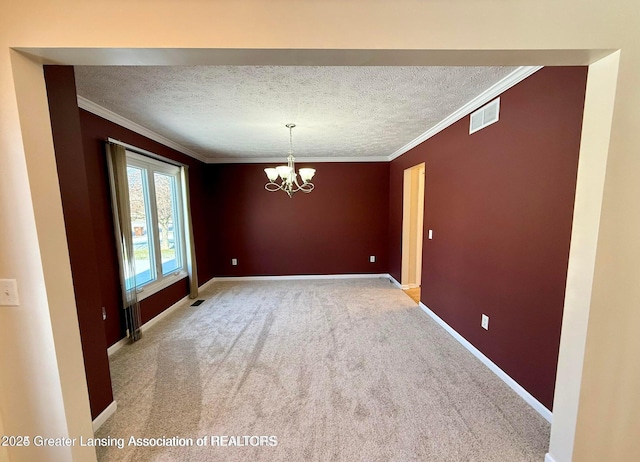 spare room featuring visible vents, baseboards, a textured ceiling, and crown molding