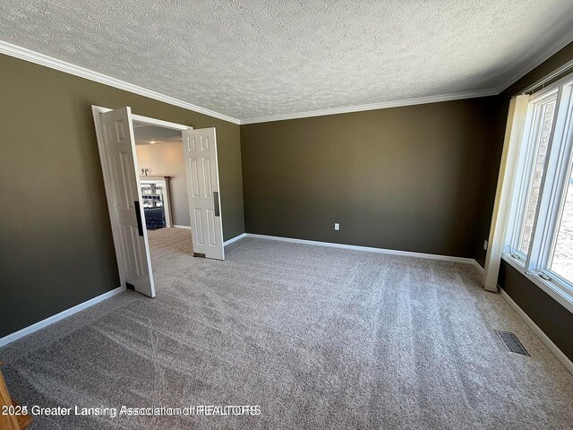 unfurnished bedroom with baseboards, visible vents, and ornamental molding