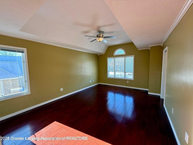 empty room featuring plenty of natural light, baseboards, and hardwood / wood-style flooring