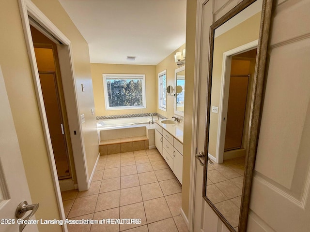 bathroom featuring vanity, visible vents, a stall shower, tile patterned flooring, and a garden tub