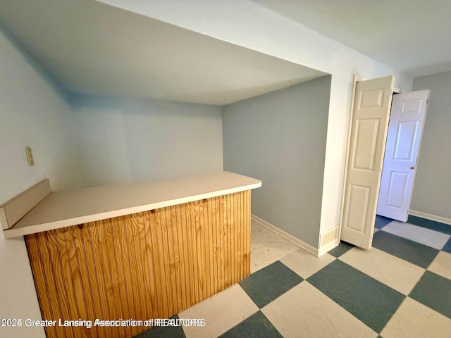 bar featuring tile patterned floors and baseboards