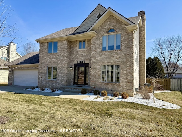 traditional-style home with a garage, fence, brick siding, and a chimney