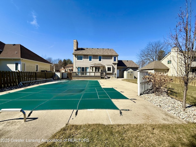 view of pool with a patio area and fence