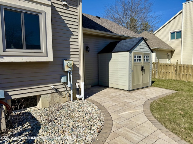 doorway to property with a yard, a patio, a shingled roof, and fence