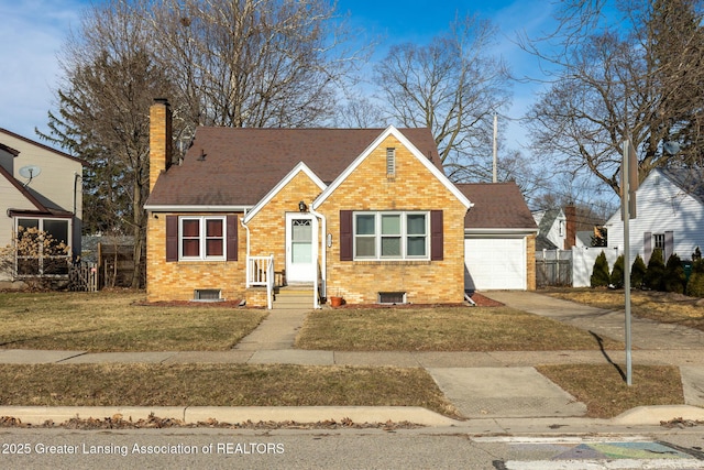 view of front of house with brick siding, a chimney, a front lawn, and fence