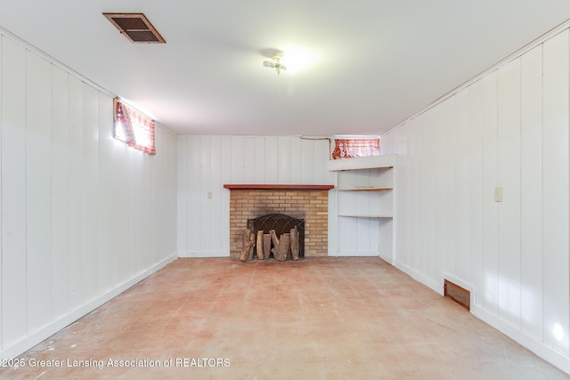 unfurnished living room featuring a brick fireplace and visible vents