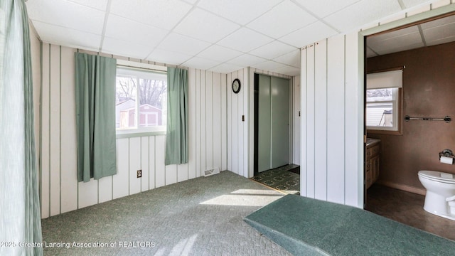 unfurnished bedroom featuring visible vents and a drop ceiling