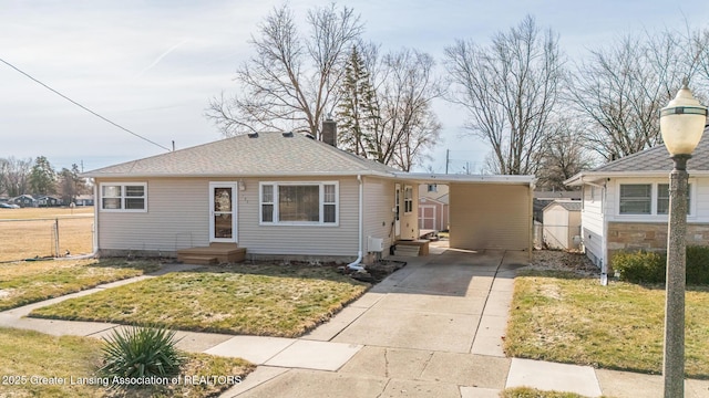 bungalow-style house featuring an attached carport, driveway, a front yard, and fence