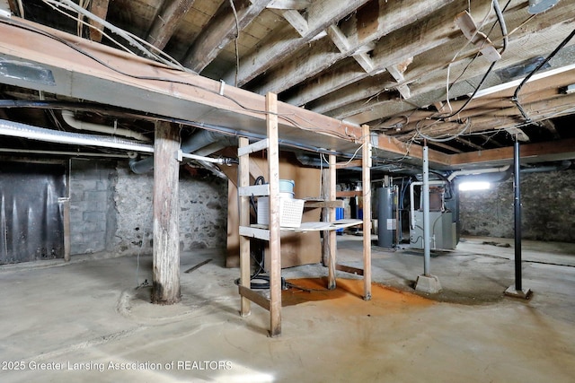 unfinished basement with water heater and heating unit