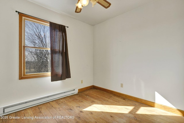 spare room with baseboard heating, ceiling fan, baseboards, and hardwood / wood-style flooring