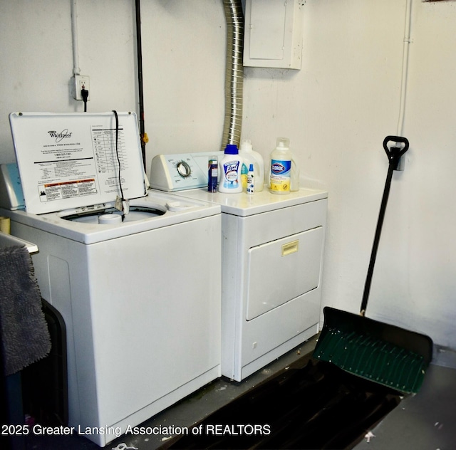 laundry room featuring washing machine and clothes dryer, laundry area, and electric panel