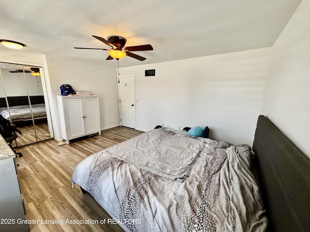 bedroom with a closet, a ceiling fan, and wood finished floors