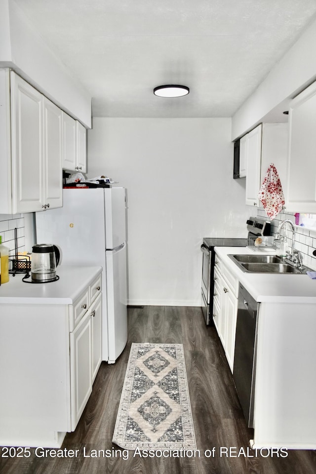 kitchen featuring dark wood finished floors, white cabinetry, stainless steel appliances, and a sink