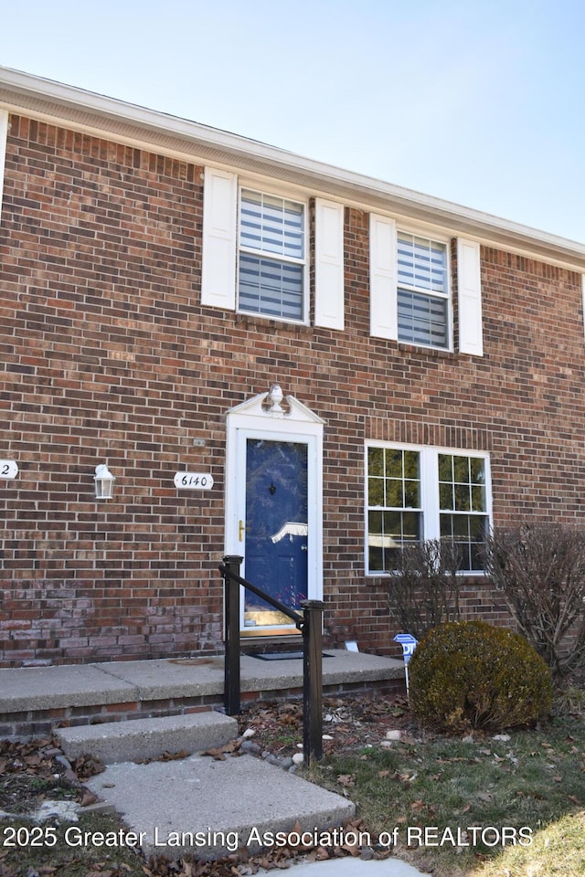 view of front of house featuring brick siding