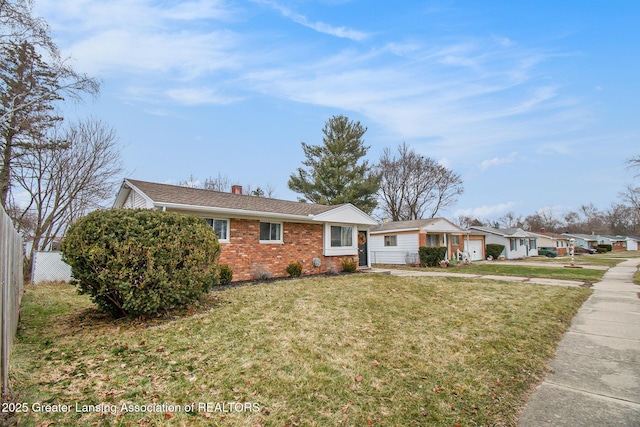 ranch-style house with brick siding, a chimney, a front yard, and fence