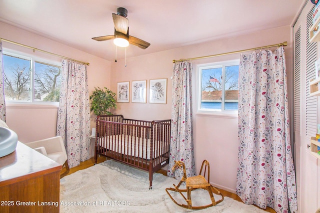 bedroom with a crib and multiple windows